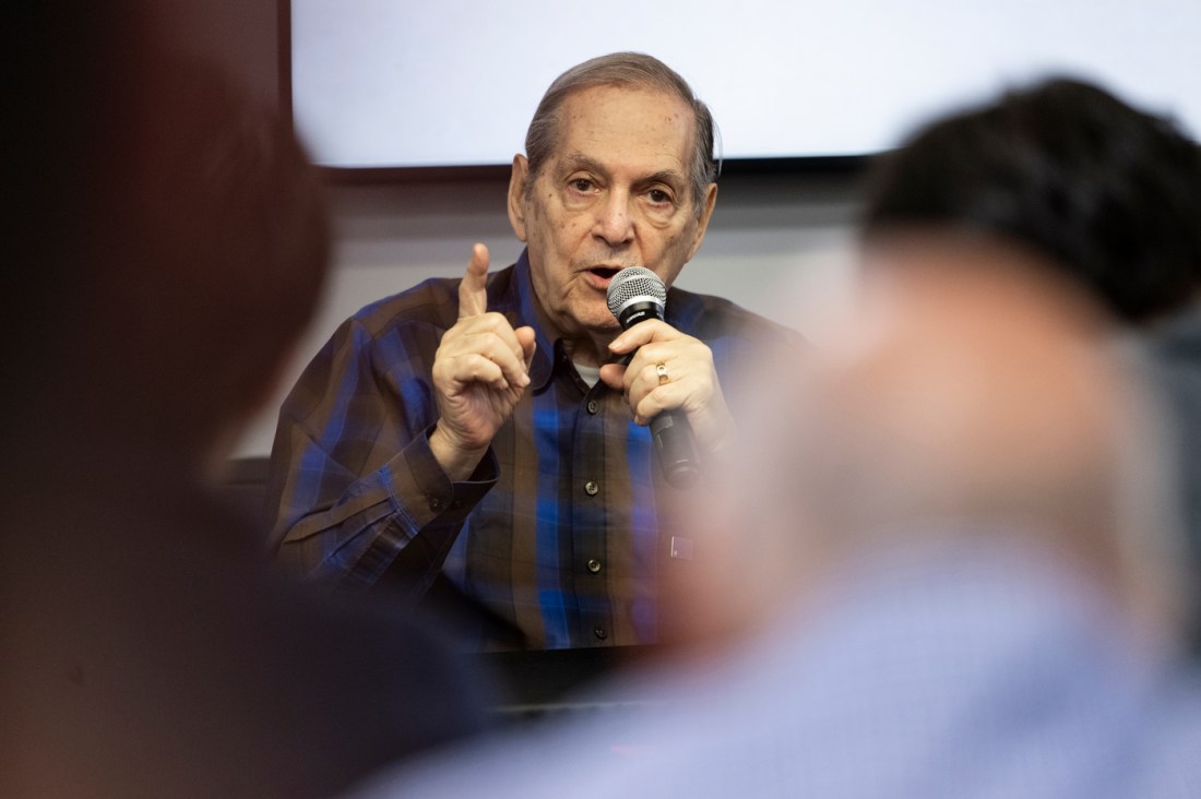 Dr. Joseph Berger speaking into a microphone.
