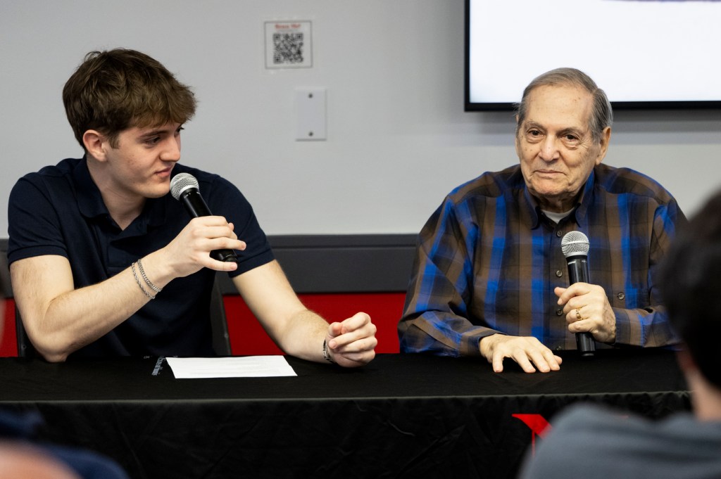 Noah Ben-Zion and Dr. Joseph Berger sitting next to each other holding microphones.