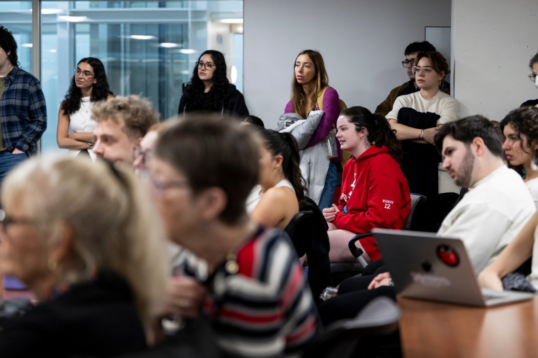 Audience members sitting in a room for a Holocaust Week Survivor Lecture.