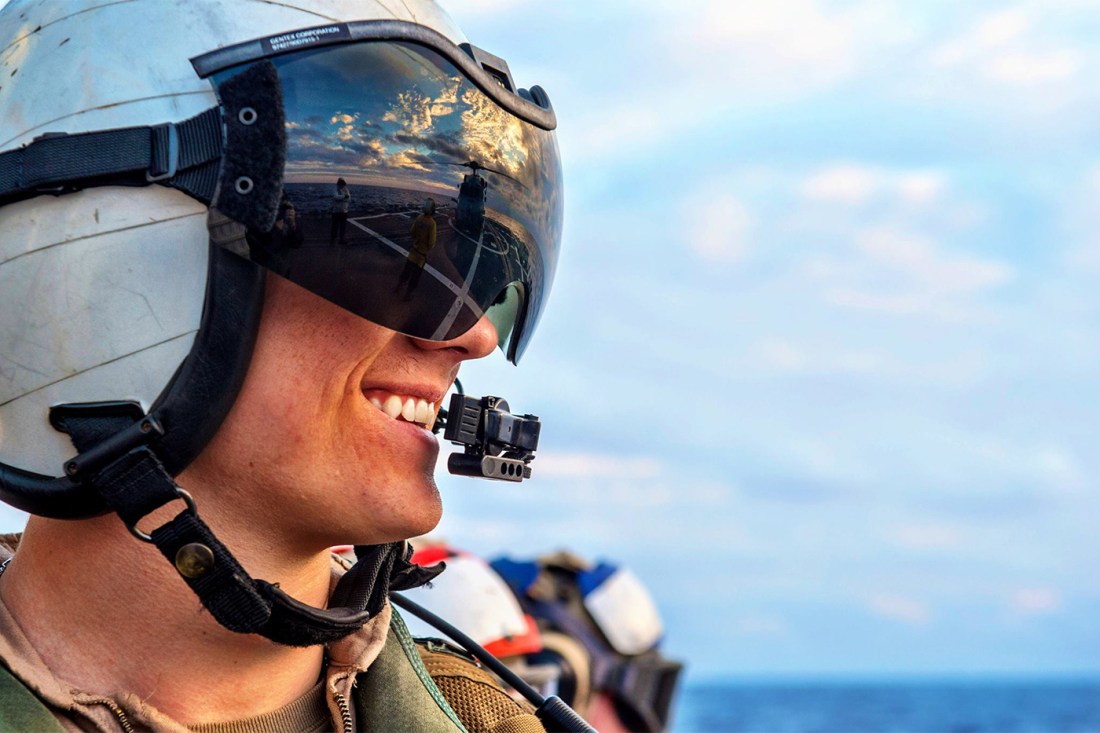 Portrait of Evan Kenny wearing a Naval helmet and goggles.