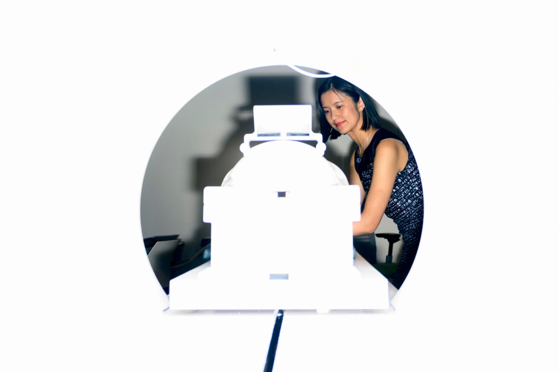 Zhenghan Qi working with an MRI machine.