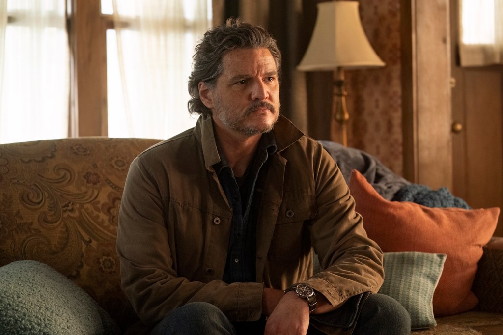 A screen capture from 'The Last of Us' that shows Pedro Pascal sitting on a couch.