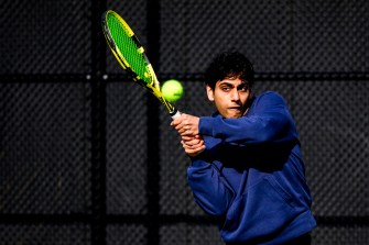 A person hitting a tennis ball with a racquet.