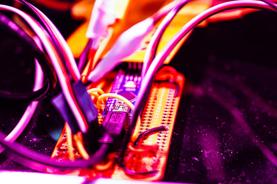 Wires going into a switchboard.