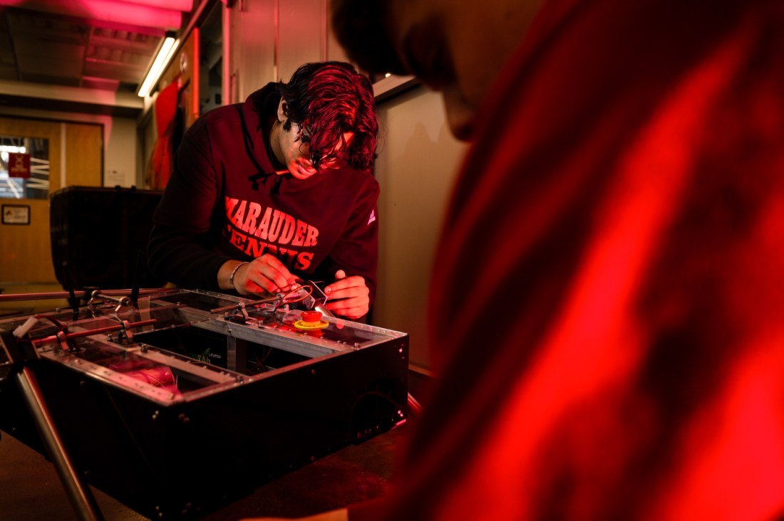 Bryan Thomas and Matt Geisel working on a robot.