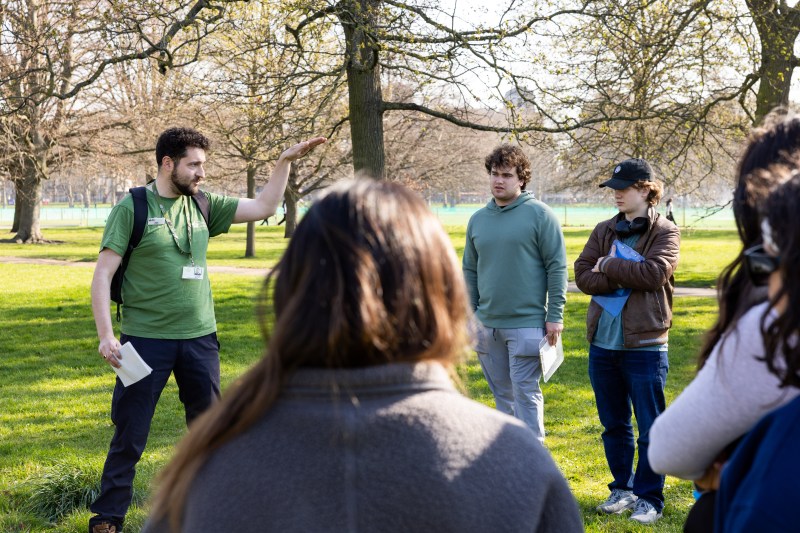 A group of students standing on the grass in Hyde Park. 