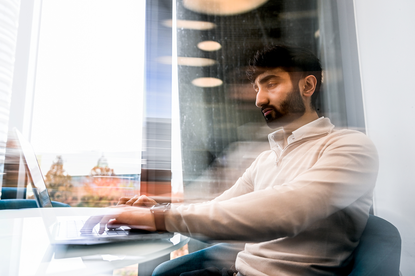 Saad Abdullah working at a laptop.