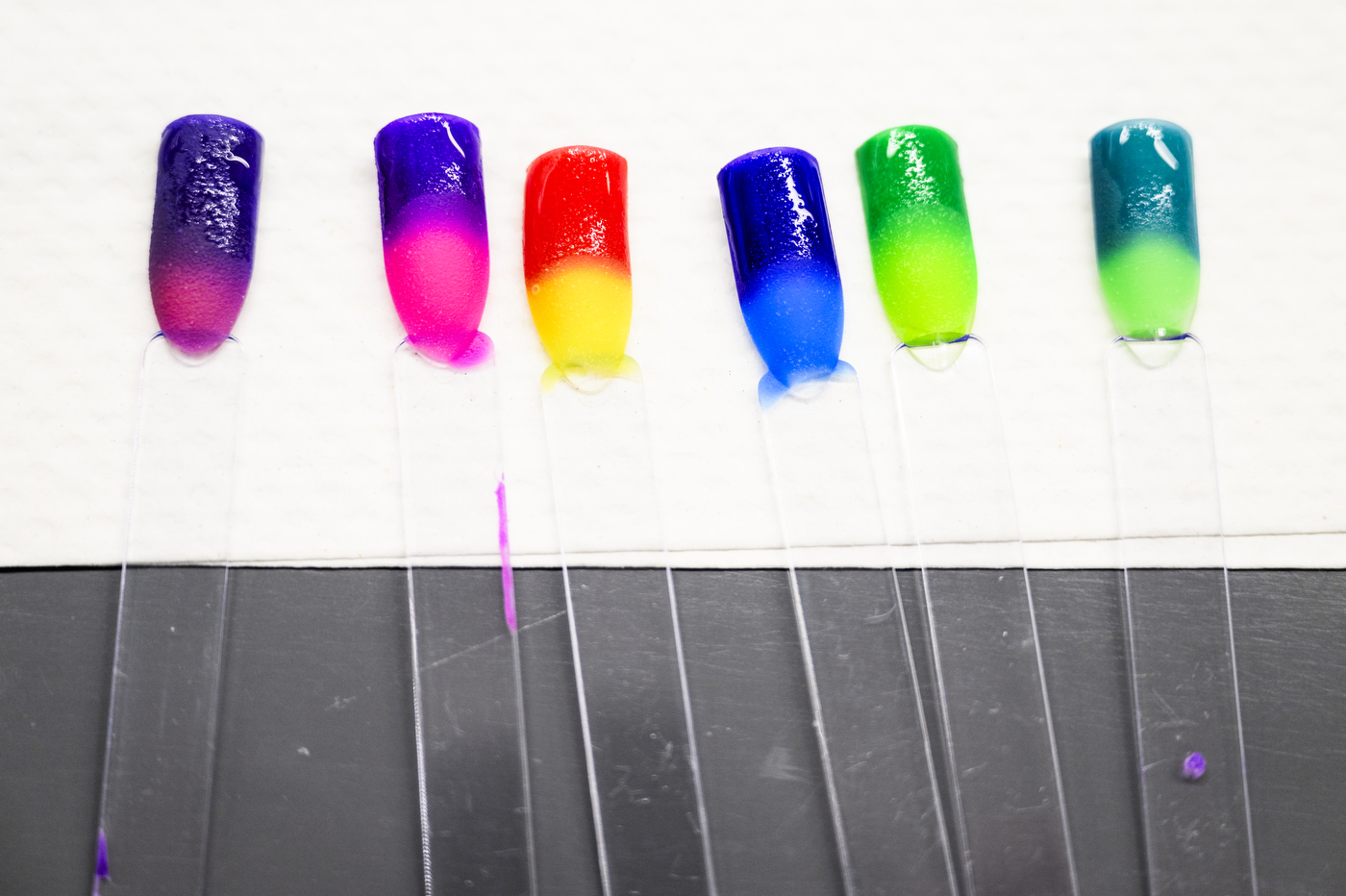 A line of colorful nail polish samples created in a chemistry class.