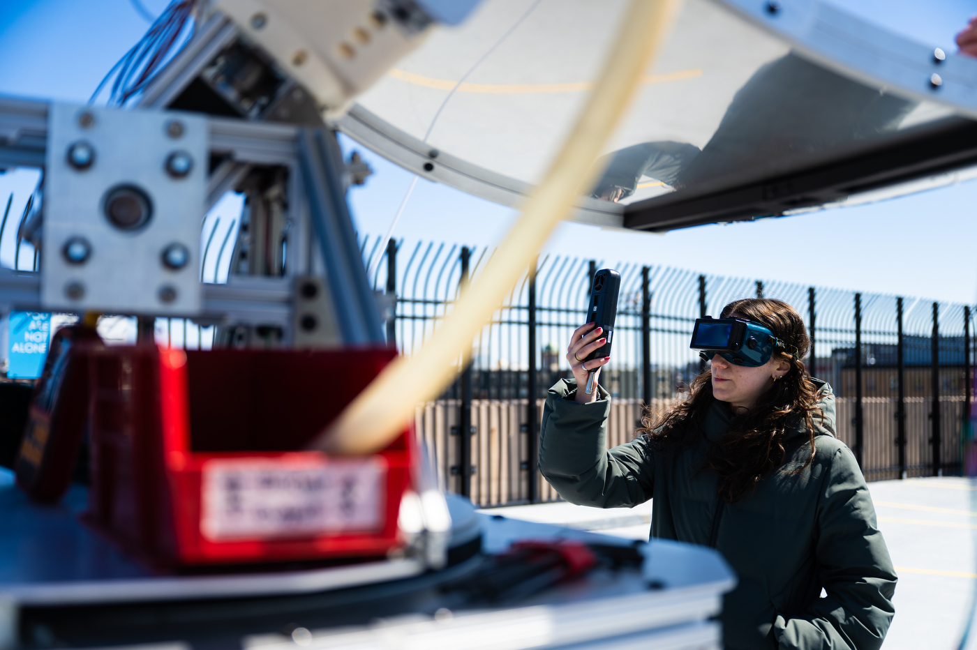 A student adjusting an engineering capstone project.