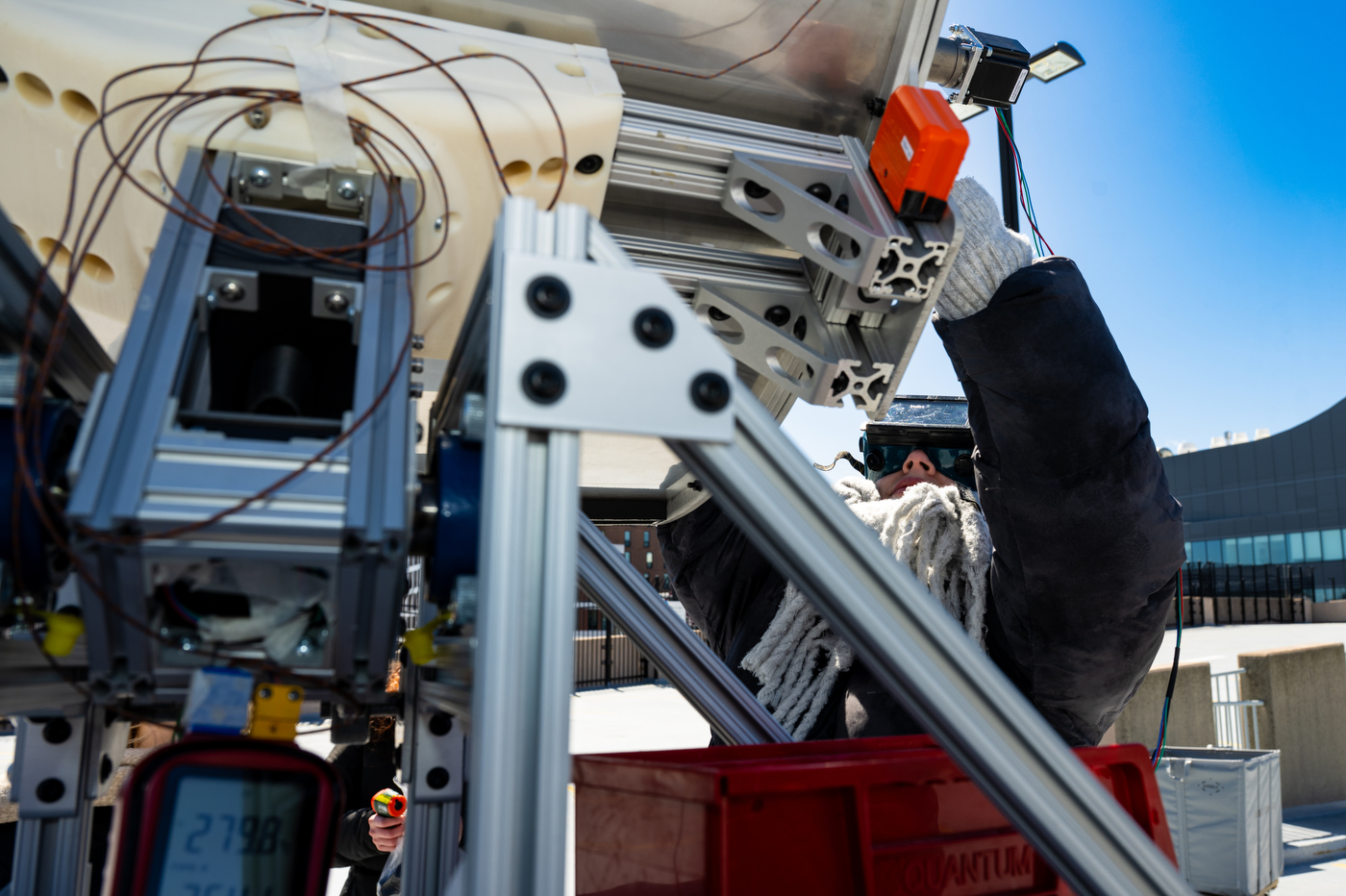 A student adjusting an engineering capstone project.