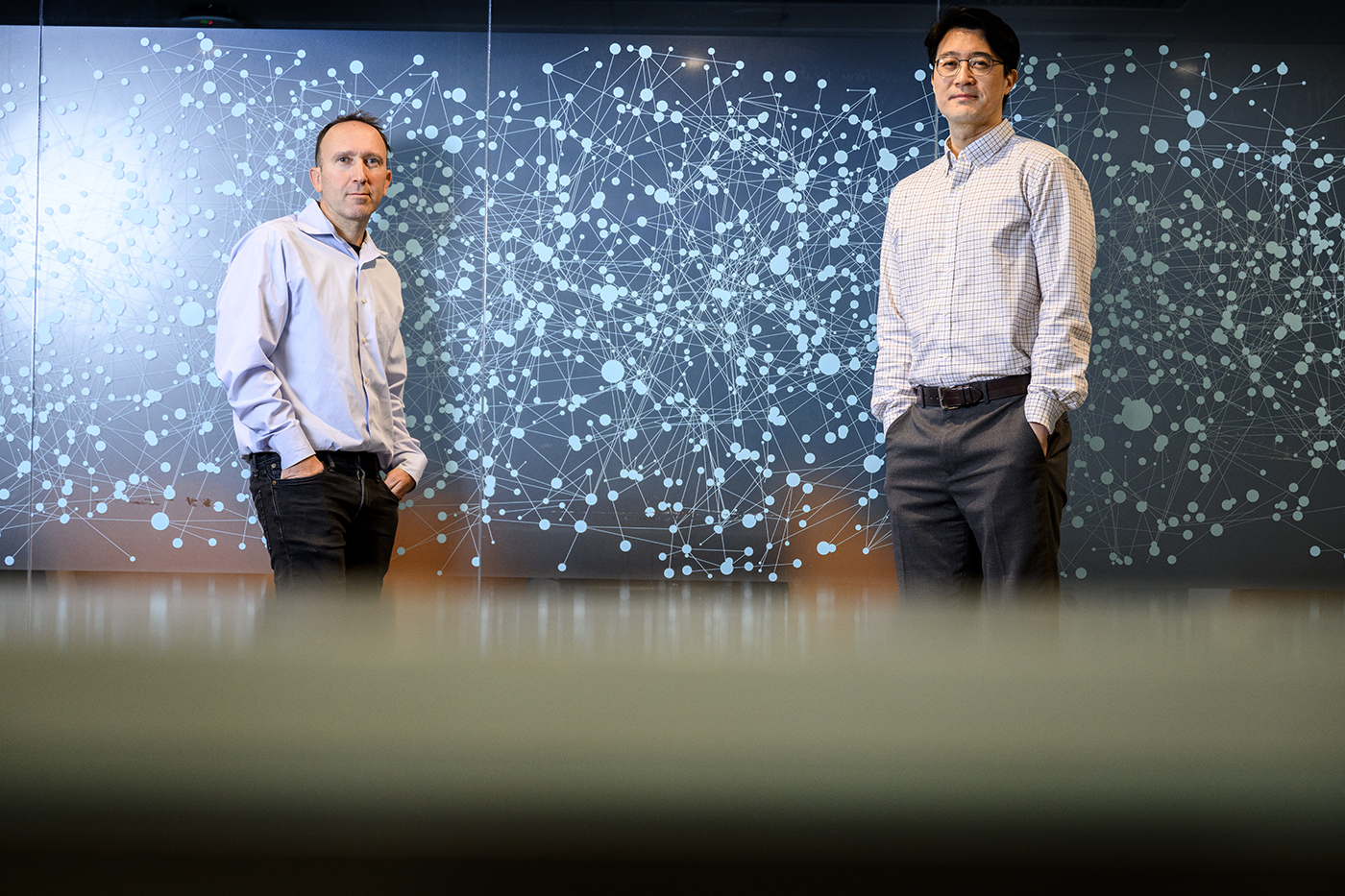 Portrait of Udi Hoitash and Jaehan Ahn standing in the same room.