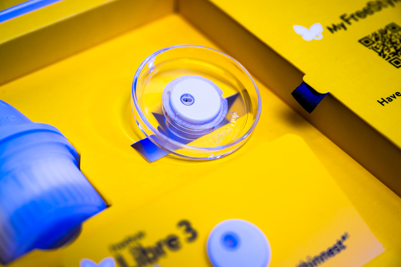 A glucose monitoring kit in a yellow box.