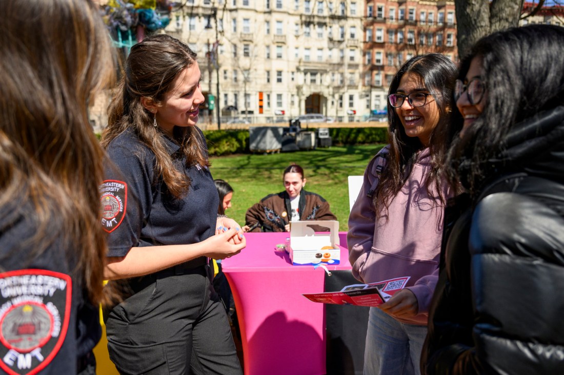 Two EMTs talking with students at the Giving Day 2025.