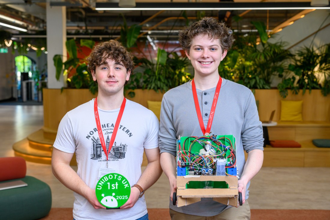 Daniel Brightman and Asher Hunter posing with their robot.
