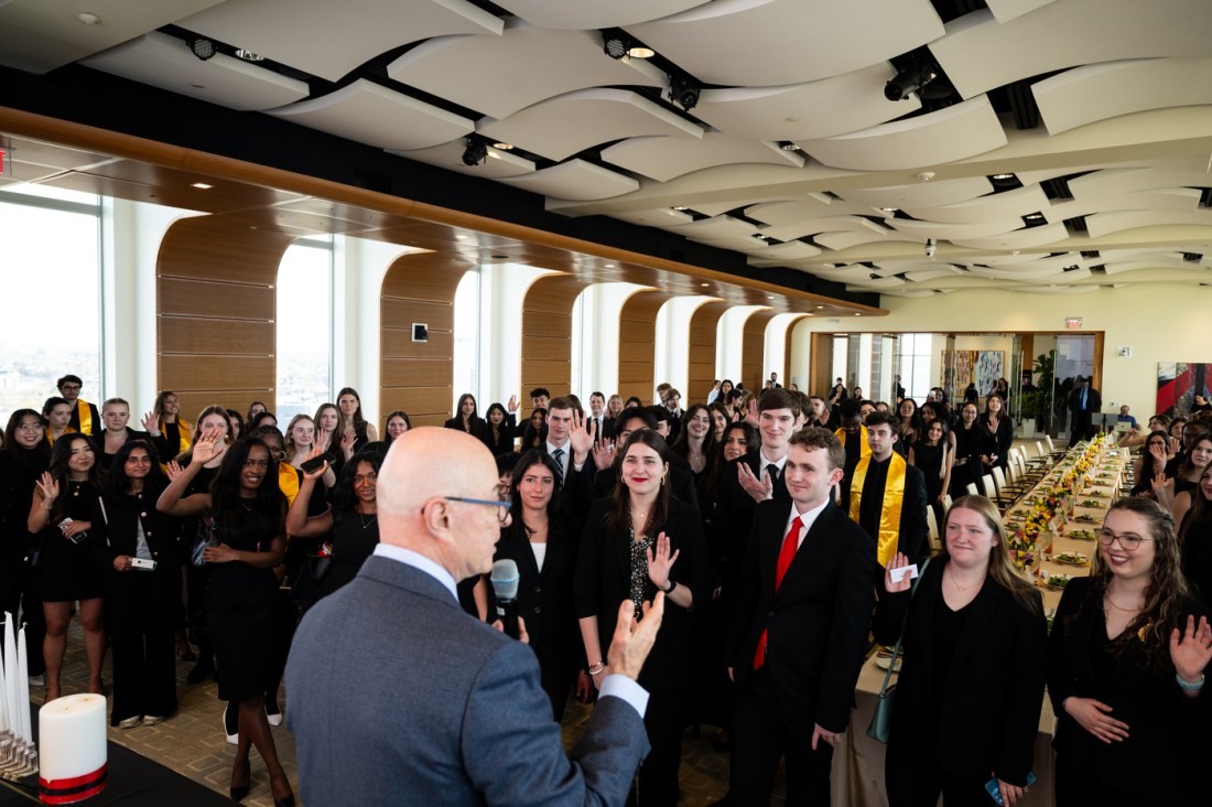 President Aoun speaking at the front of a room full of Huntington 100 Inductees.