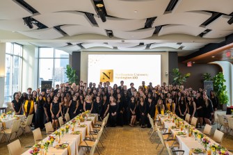 The spring 2025 Huntington 100 inductees posing for a group photograph.