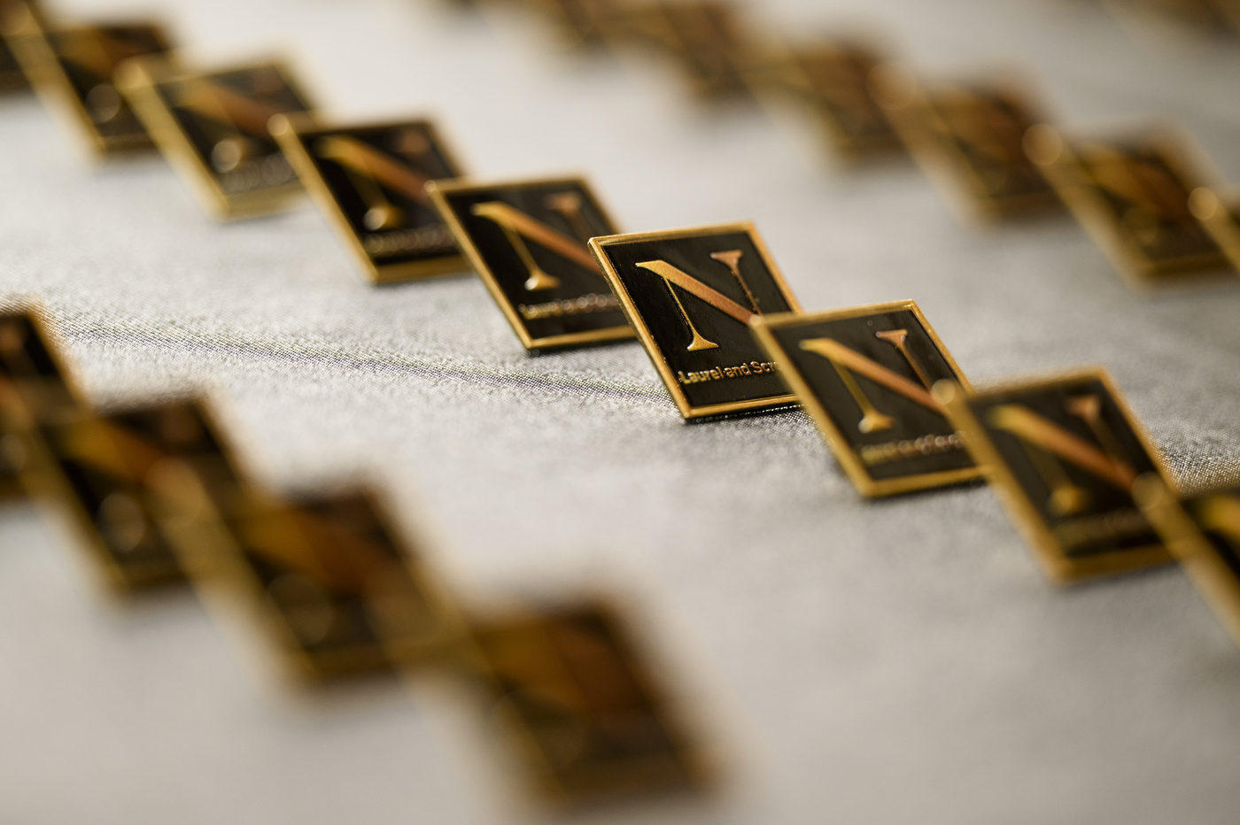 Rows of Northeastern branded pins laid out.
