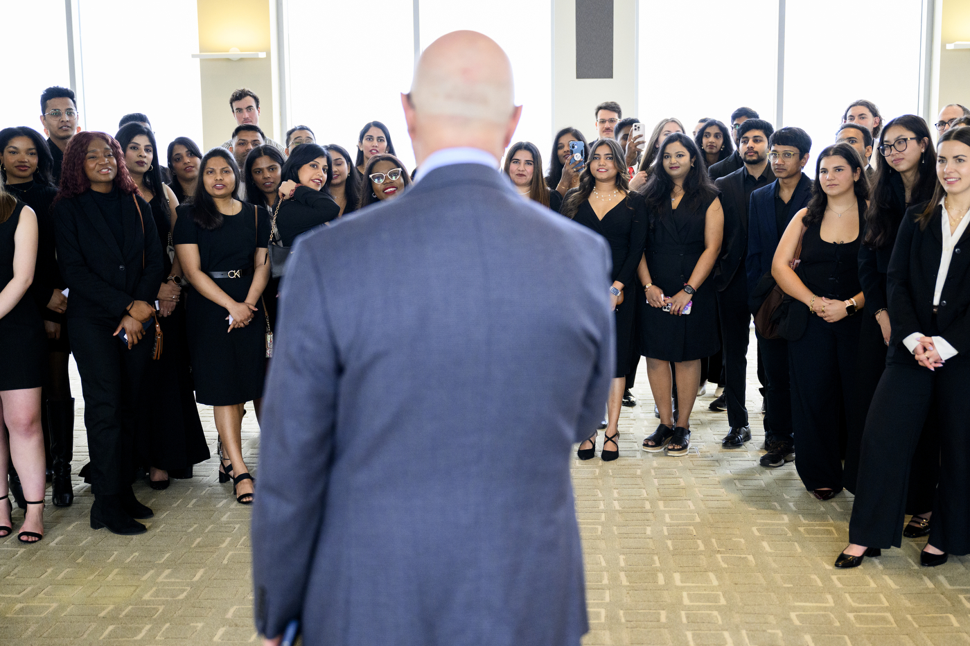President Aoun standing in front of a group of students at the Laurel & Scroll Induction Ceremony.