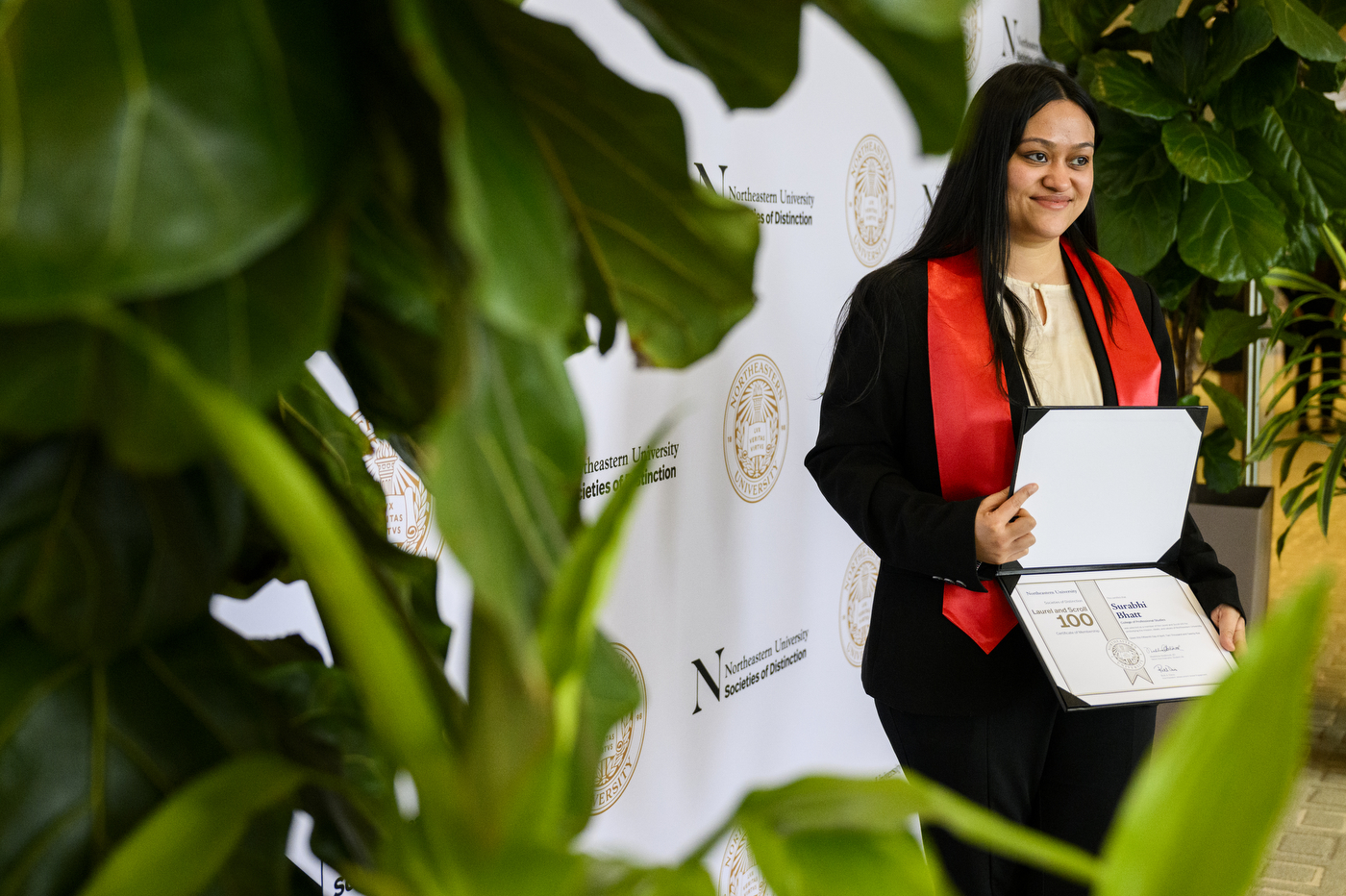 A student posing for a photo at the Laurel & Scroll Induction Ceremony.
