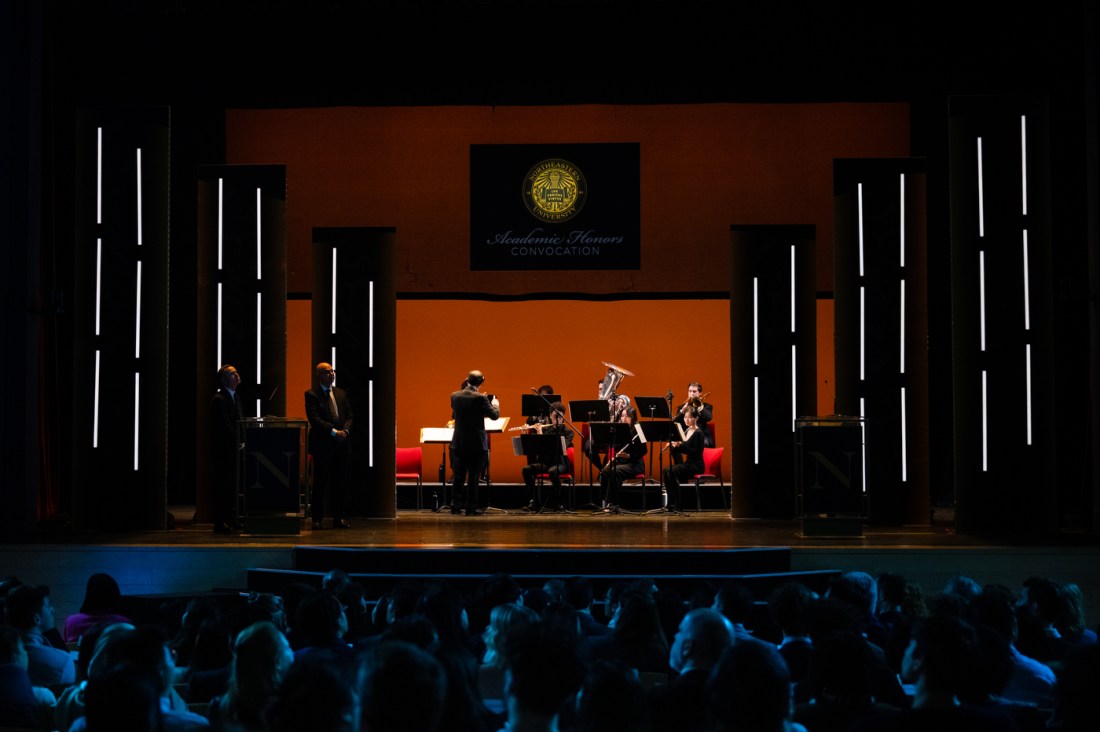 An orchestra playing on stage in Blackman auditorium.