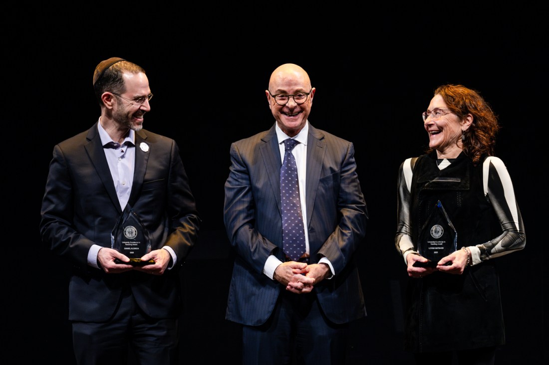 President Aoun standing with two other members of the Northeastern community on stage at the Academic Honors Convocation.