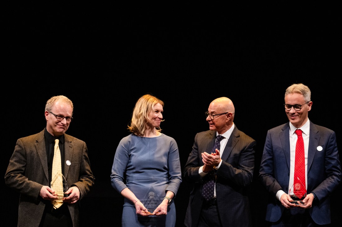 President Aoun standing with three other members of the Northeastern community on stage at the Academic Honors Convocation.