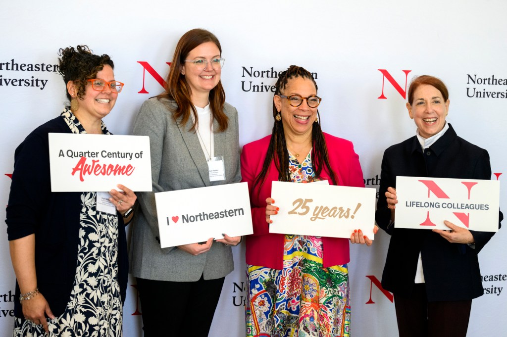 Four members of the Northeastern community posing at the 25 year associates brunch.