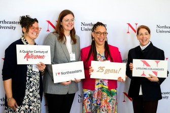 Four members of the Northeastern community posing at the 25 year associates brunch.