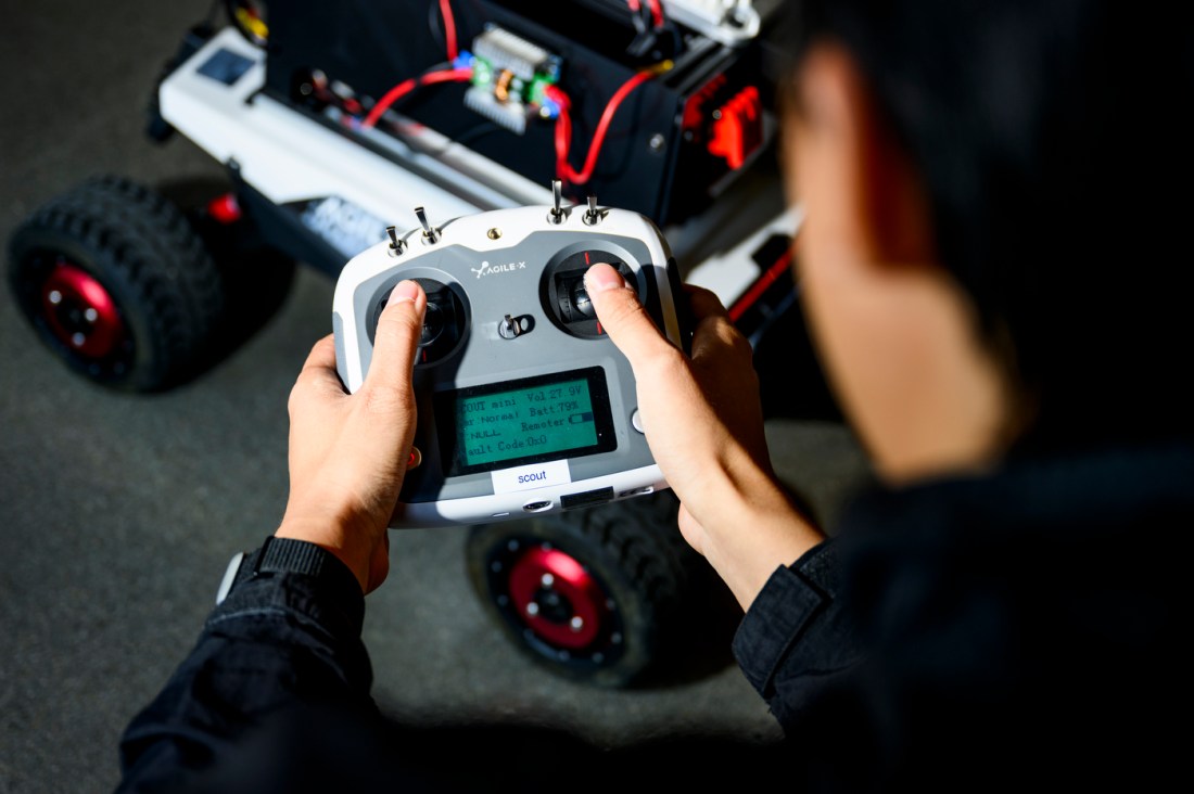 Zihao Dong installing an autonomy kit on a robot.