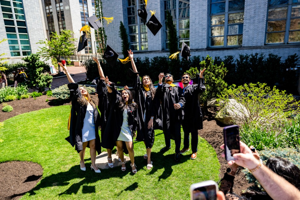 A group celebrates outdoors on a sunny day.