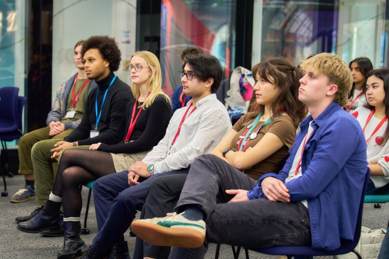 Northeastern community members sitting in rows listening at a psychology conference.