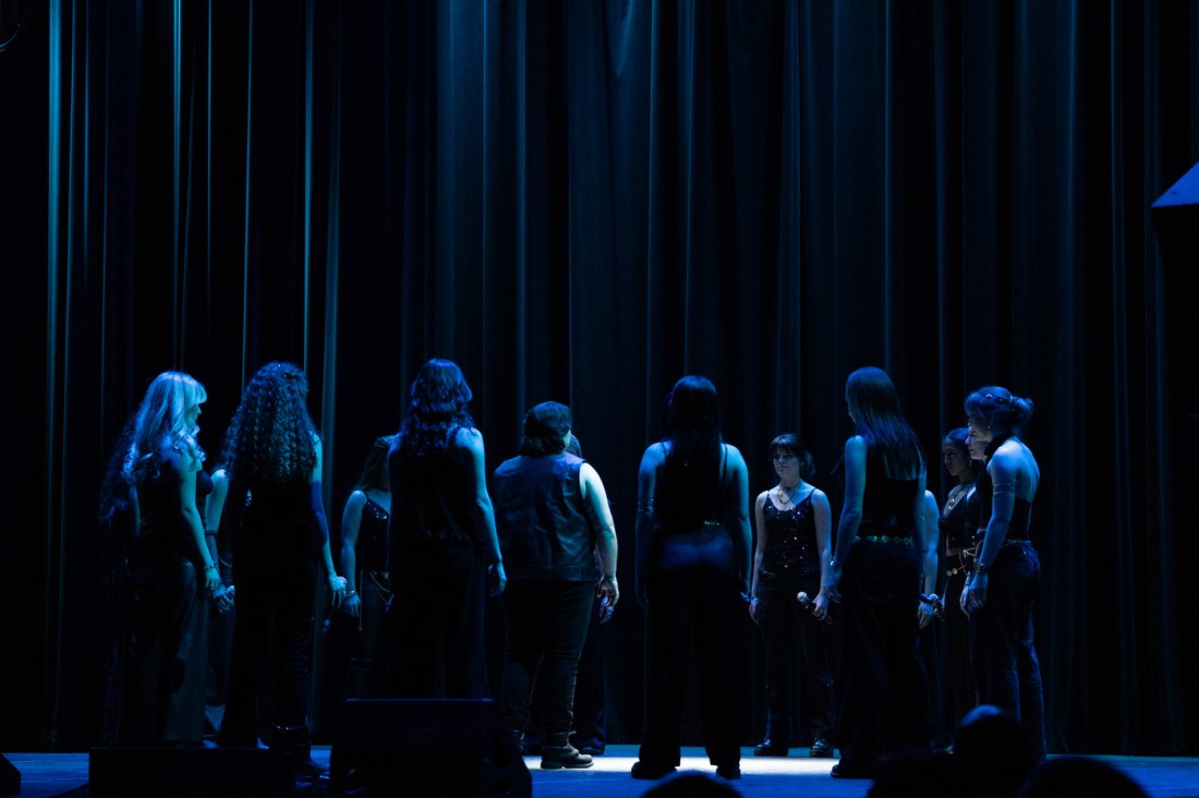 A capella singers on stage at a competition.