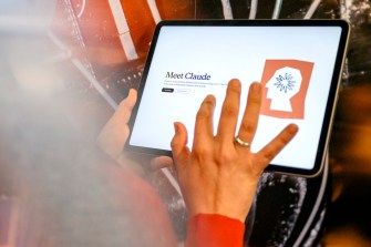 A person opening Claude AI on an iPad.
