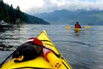 Two people kayaking in Deep Cove, North Vancouver.