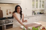 Meghan Markle, Duchess of Sussex, smiles while hosting in a kitchen during an episode of her Netflix series With Love, Meghan, part of her lifestyle brand launch.