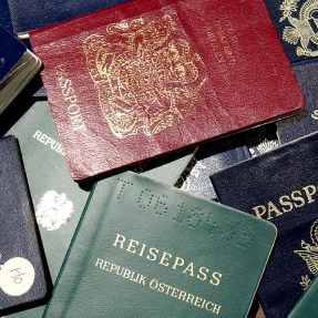 A stack of passports from different countries.