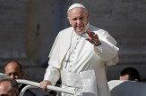 Pope Francis waves to a crowd while standing in a vehicle during a public appearance outside St. Peter’s Square.