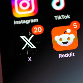 The Redit app next to the X app on a phone sscreen.