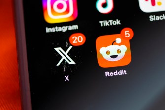 The Redit app next to the X app on a phone sscreen.