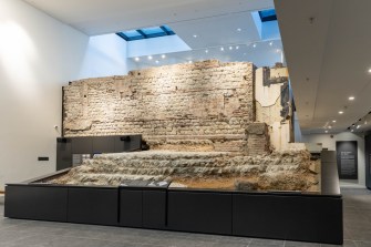 A section of a Roman wall inside of a building.