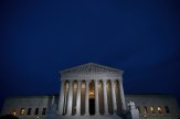 Exterior view of a courthouse illuminated at night.