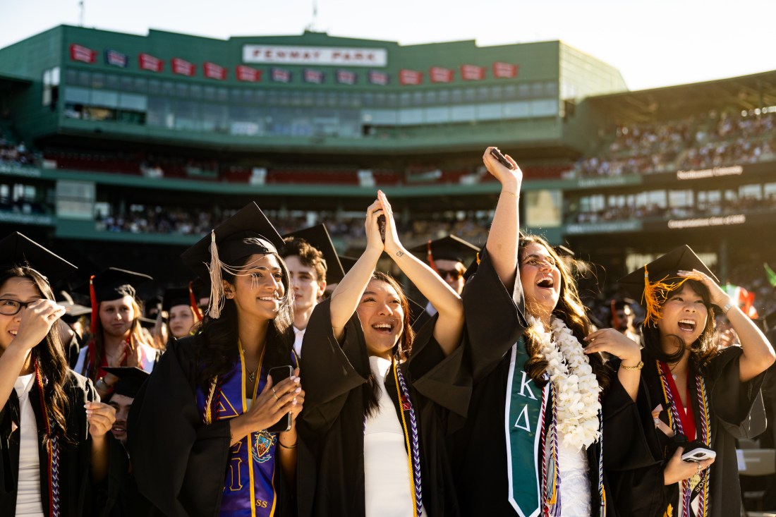 Graduates cheer and clap during Northeastern’s 2025 Commencement ceremony at Fenway Park.