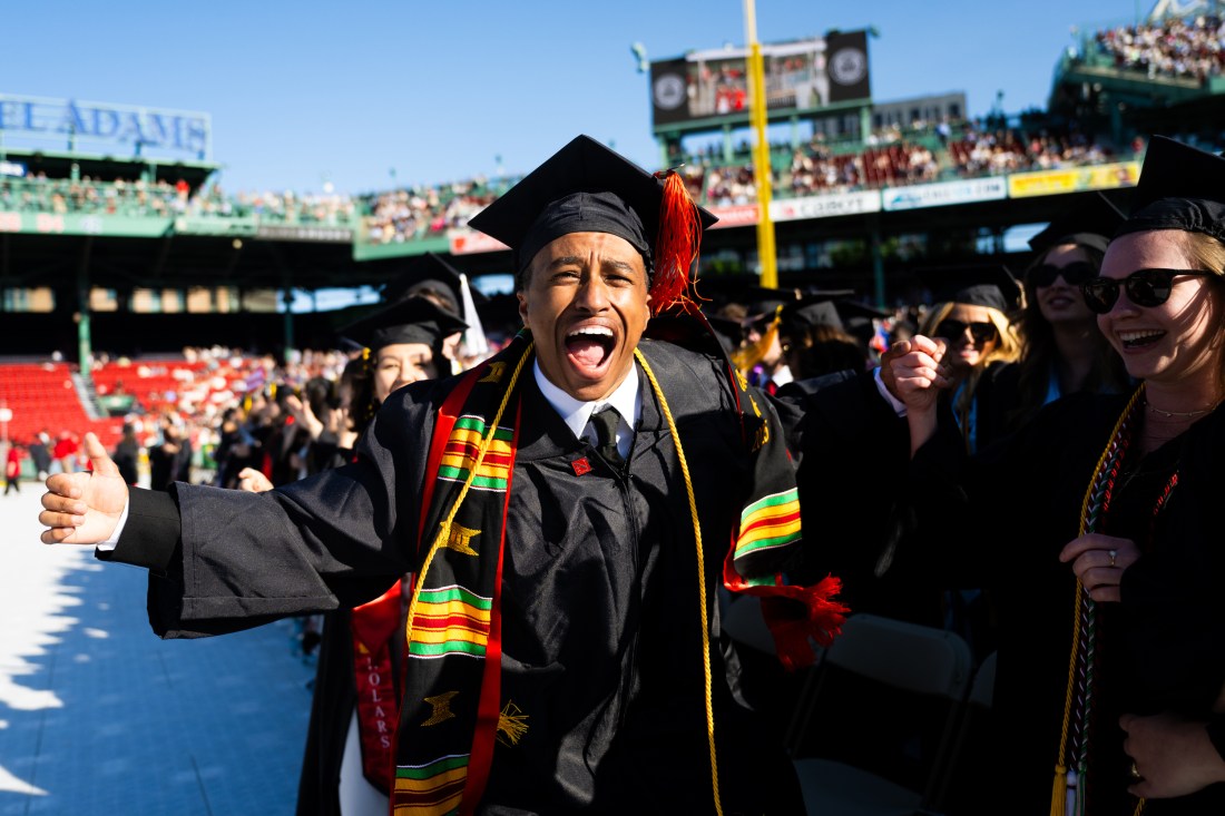 A Northeastern graduate celebrates at Fenway Park during the 2025 undergraduate commencement ceremony.