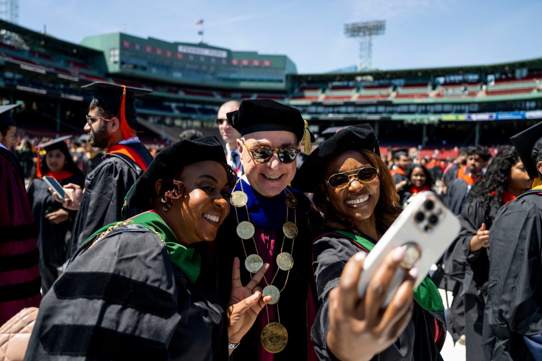 Graduates gather on the field at Fenway Park during Northeastern’s 2025 Commencement.