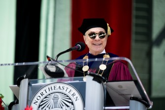 President Aoun speaks on stage at Northeastern’s Graduate Commencement ceremony at Fenway Park.