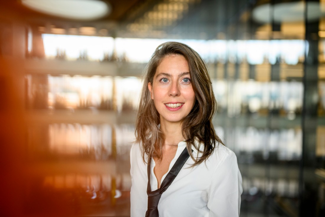 Portrait of Cansu Canca wearing a white button down and a black tie.