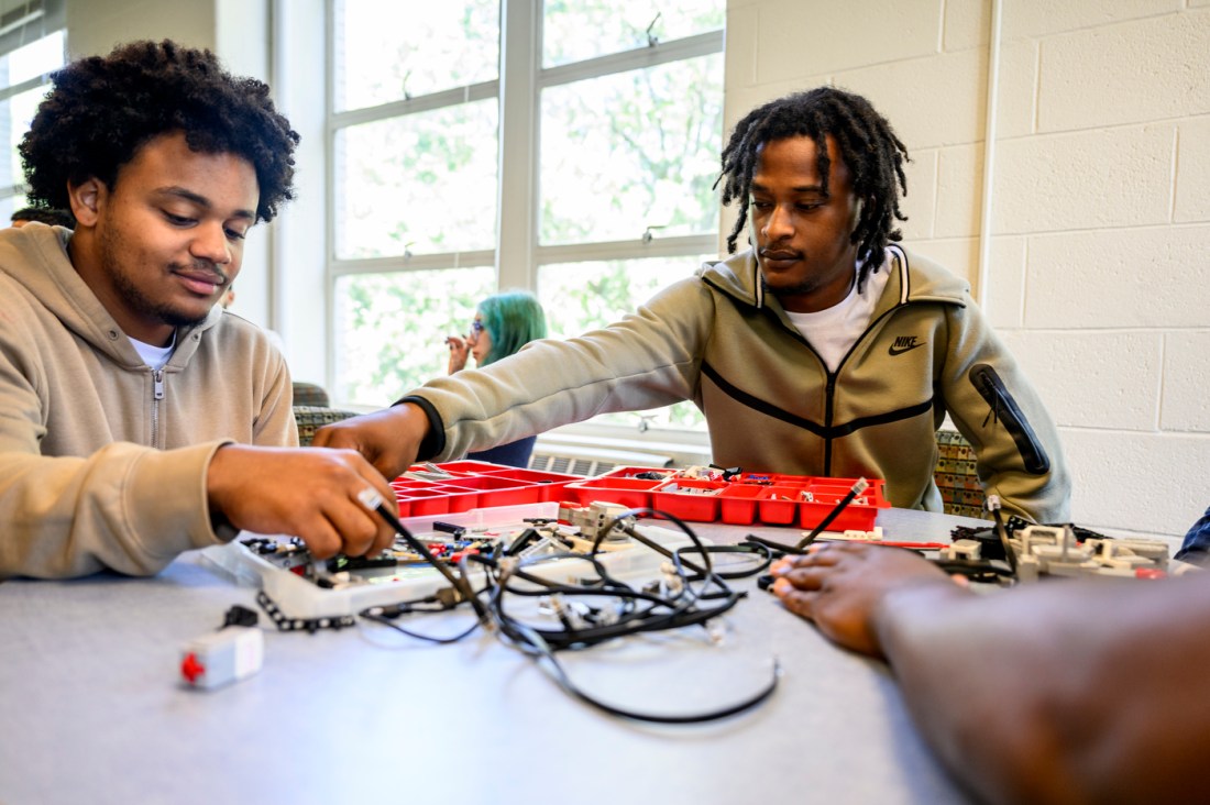 Students swapping pieces and working together on robots.