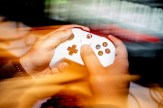 A blurred image of a person holding a video game controller.