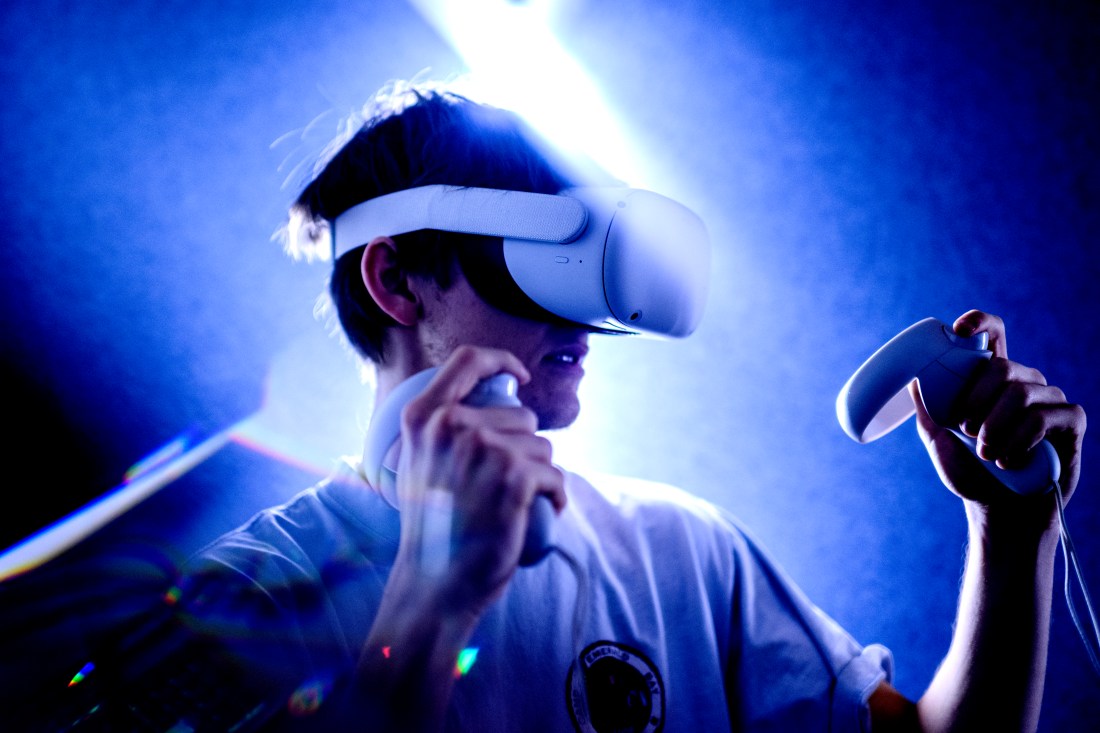 A person demonstrates a VR headset in a lab.