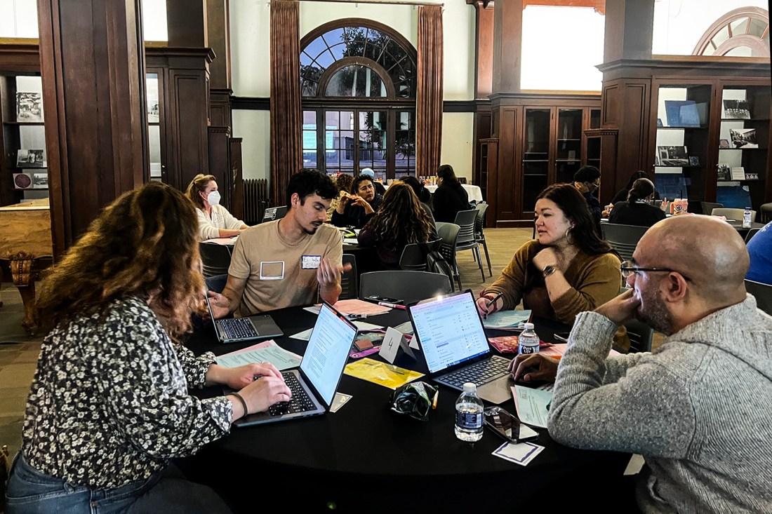 A group of people working together in a library.